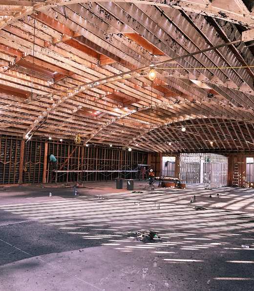 The same space mid-construction, exposed framing and structure